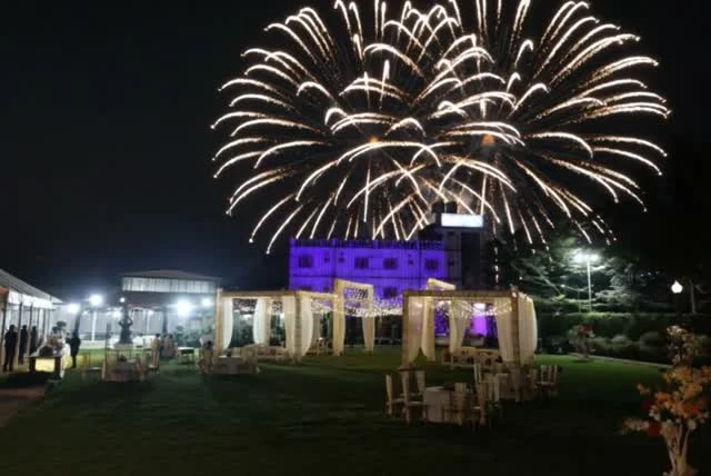 A cinematic interpretation of fireworks behind the Bhandari Farms lawn