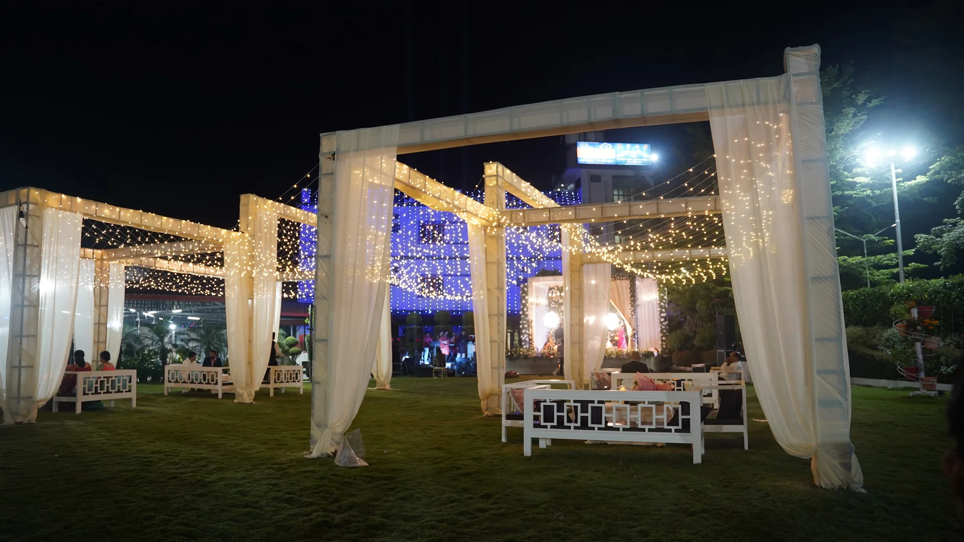 Actual draped lawn pavilions with lights and guest seating at Bhandari Farms